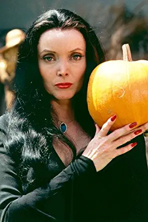 Carolyn Jones The Addams Family Color 24x36 Poster holding pumpkin